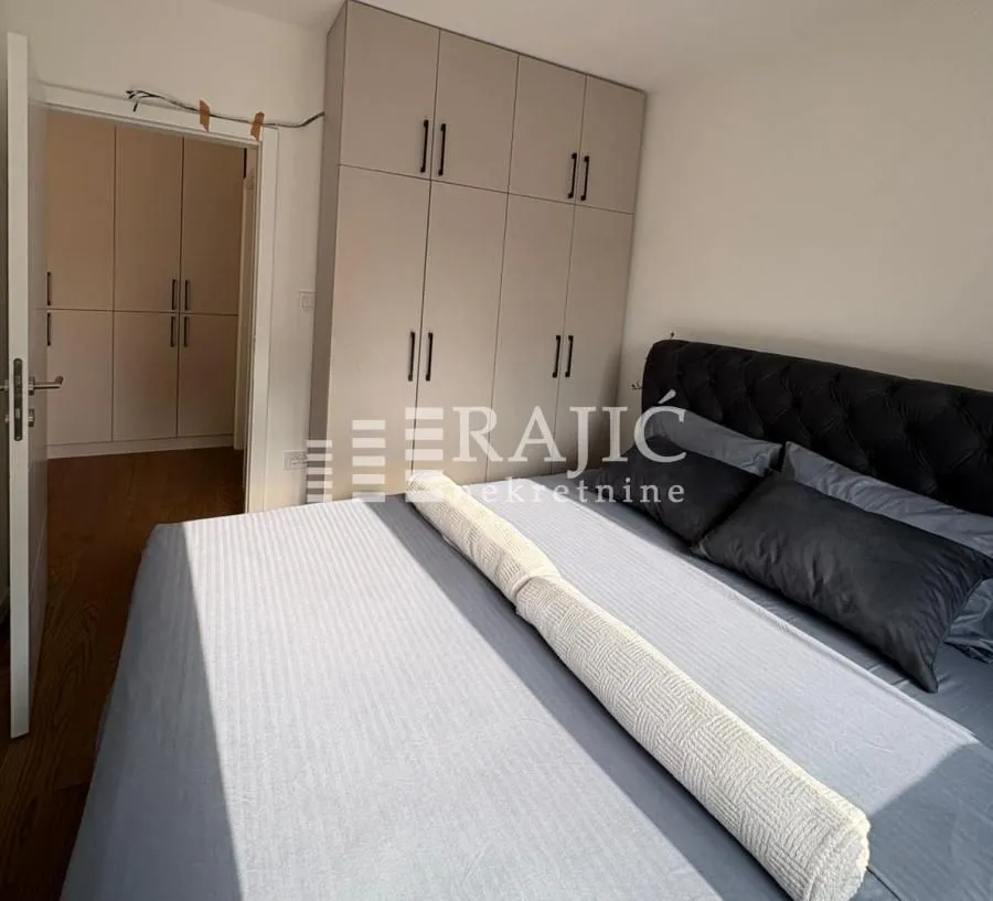 Furnished bedroom with a double bed and built-in wardrobe.