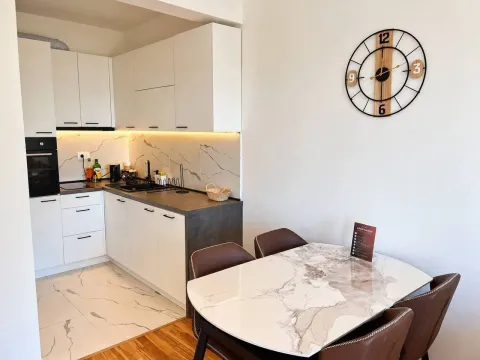 Modern kitchen with dining area and built-in appliances. - image 4