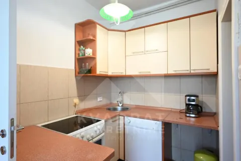 Compact kitchen with countertops, sink, and built-in stove. - image 22