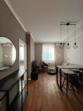 Modern and bright living room with a sofa and dining table. - image 13