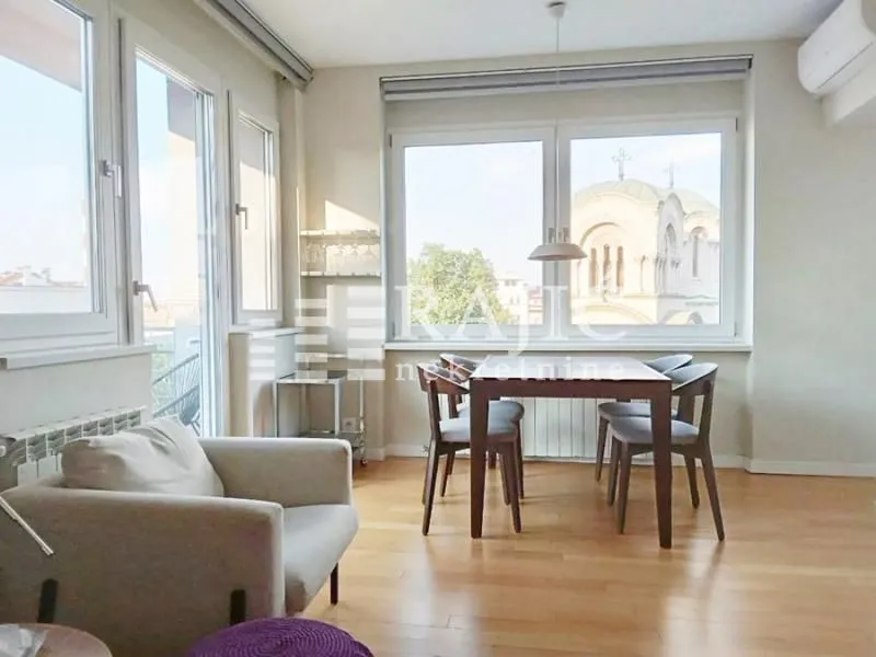 Living room with dining area and city view.