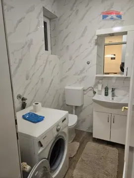 Kupatilo opremljeno umivaonikom, WC šoljom i veš mašinom. - image 18