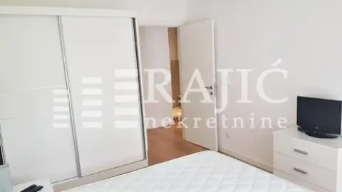 Bright bedroom with a large built-in wardrobe and a double bed. - image 5