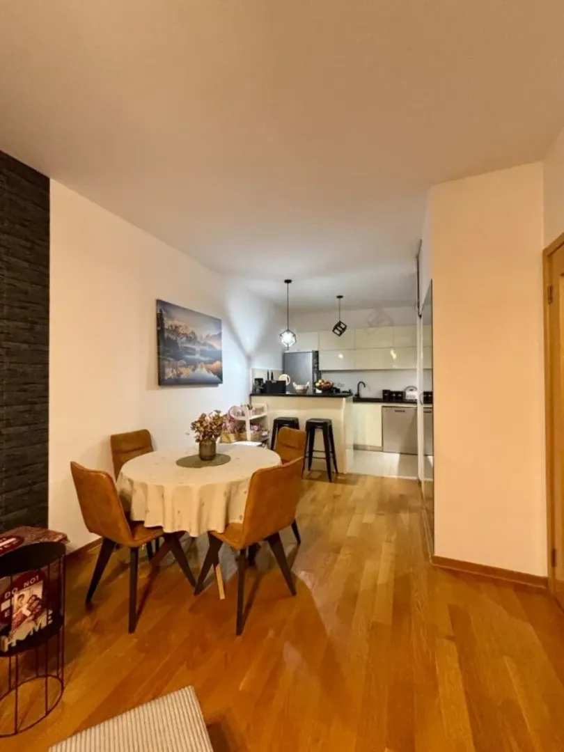 Living room with dining area and kitchen in the background.