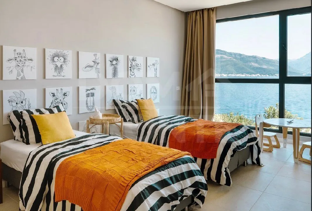 Children's bedroom with two beds and a sea view.