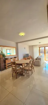Spacious living room with a dining area and seating set. - image 4