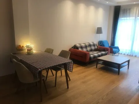 Living room with a dining table and a seating area. - image 7