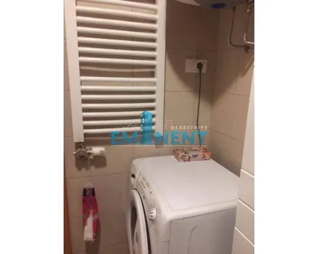 Bathroom with a washing machine and a wall-mounted radiator. - image 12