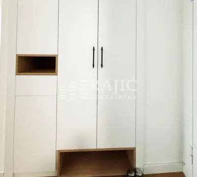Built-in white wardrobe in the room. - image 9