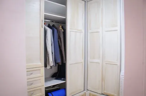 Built-in wooden wardrobe with clothes. - image 7