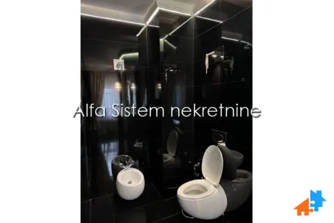 Moderno opremljeno kupatilo sa crnim pločicama i belom sanitarijom. - image 17
