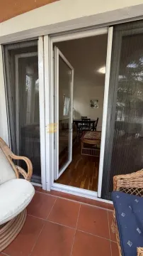 View from the tiled terrace with outdoor seating toward the interior of the apartment. - image 20