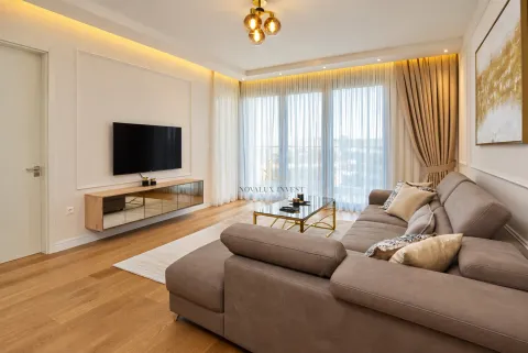 Modern and bright living room with a sectional sofa, TV unit, and access to the terrace. - image 4