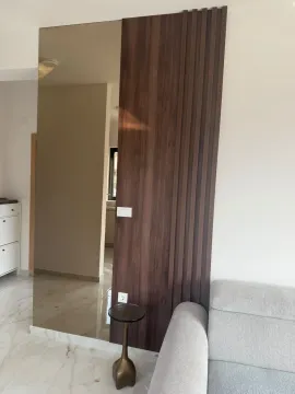 View of a living room section with wooden panels and a mirror. - image 10