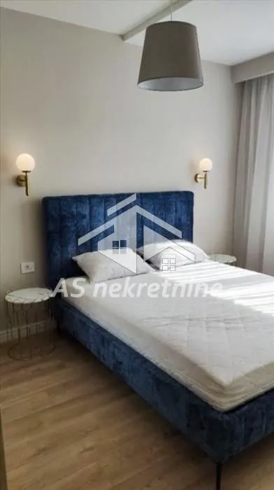 Furnished bedroom with a double bed and bedside tables.