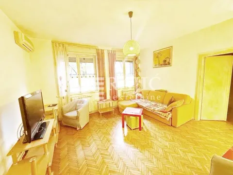 Living room with a sofa, TV, and coffee table. - image 11