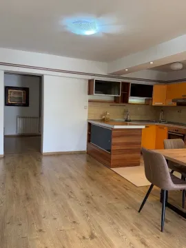 Kitchen with orange cabinets and a dining table. - image 6