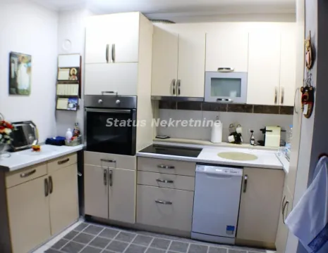 Compact kitchen with built-in cabinetry and appliances. - image 10