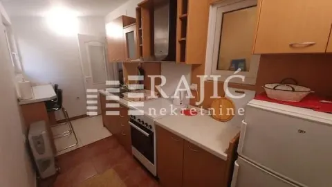 Smaller wooden kitchen with a stove and refrigerator. - image 5