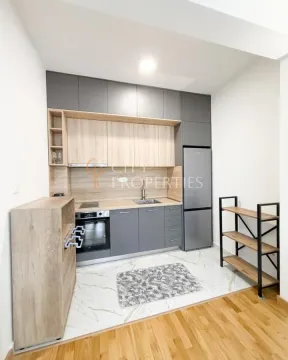 Modern kitchen with grey cabinets and built-in appliances. - image 5