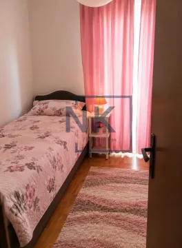 Small bedroom with a bed and pink curtains. - image 5