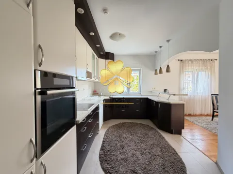 Modern kitchen with white and dark cabinets and a built-in oven. - image 7