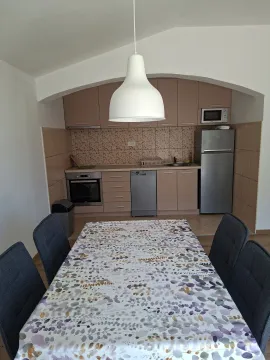 Kitchen with dining table and chairs. - image 3