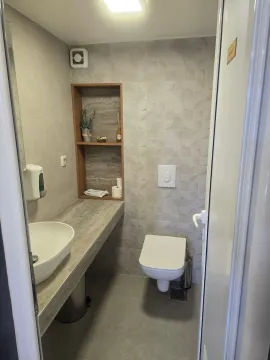 Modernly equipped bathroom with a sink and toilet. - image 10