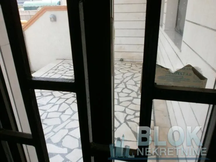 View through the door to the paved courtyard.