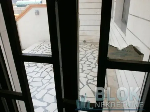 View through the door to the paved courtyard. - image 7