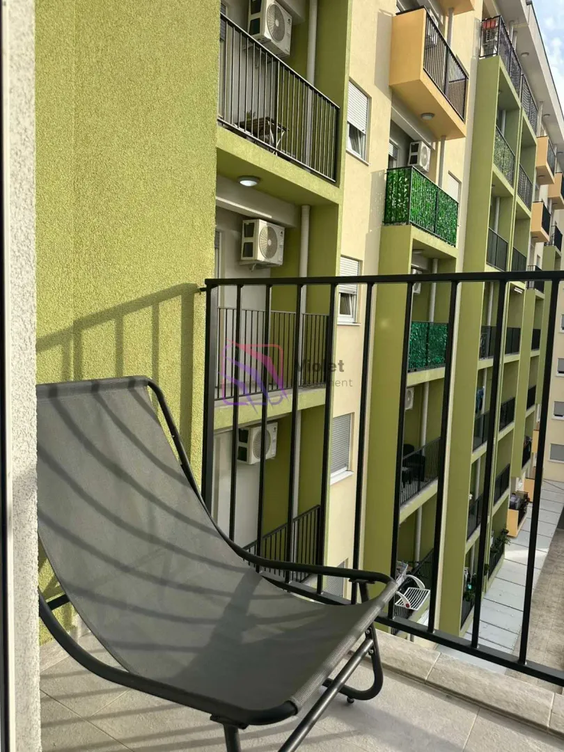View from the balcony overlooking the building facade and surrounding terraces.
