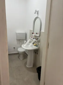 Smaller bathroom with a sink, mirror, and toilet. - image 8