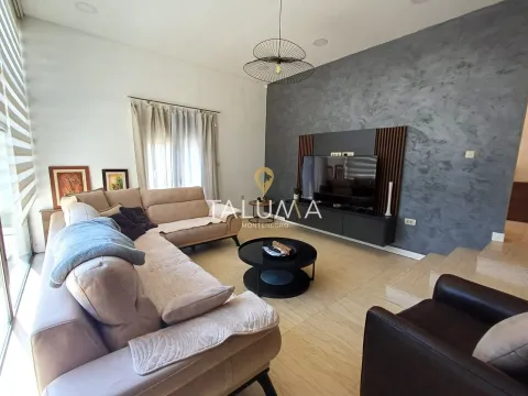 Spacious living room with a corner sofa and a TV on the wall. - image 2