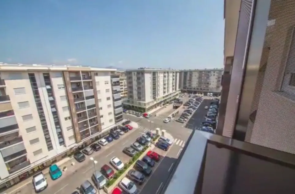 View of the city neighborhood and parking lot from the terrace.