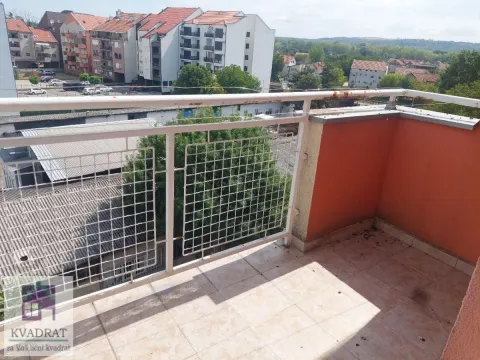 Small tiled balcony with a metal railing and a view of the neighborhood. - image 23