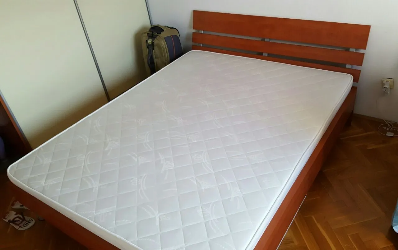 Bedroom with a double bed and wooden flooring.