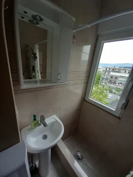 Smaller bathroom with a sink, mirror, and window. - image 6