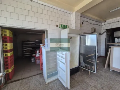 Commercial kitchen with refrigerators and tiled walls. - image 16