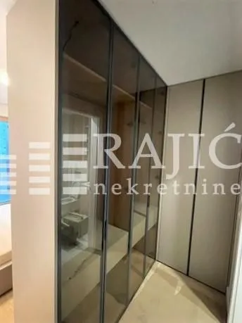 Modern wardrobe with glass doors in the bedroom.