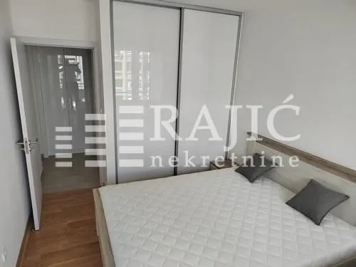 Furnished bedroom with a double bed and built-in wardrobe.