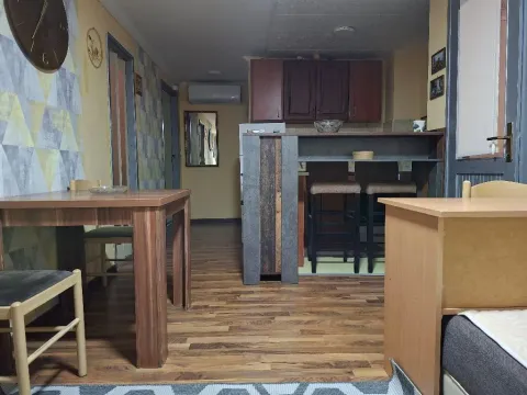 Living room with dining area and a bar counter in the background. - image 5