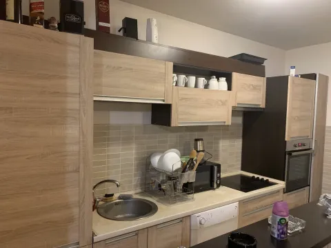 Kitchen with wooden cabinets and appliances. - image 6