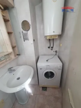 Kupatilo sa umivaonikom, veš mašinom i bojlerom na zidu. - image 11