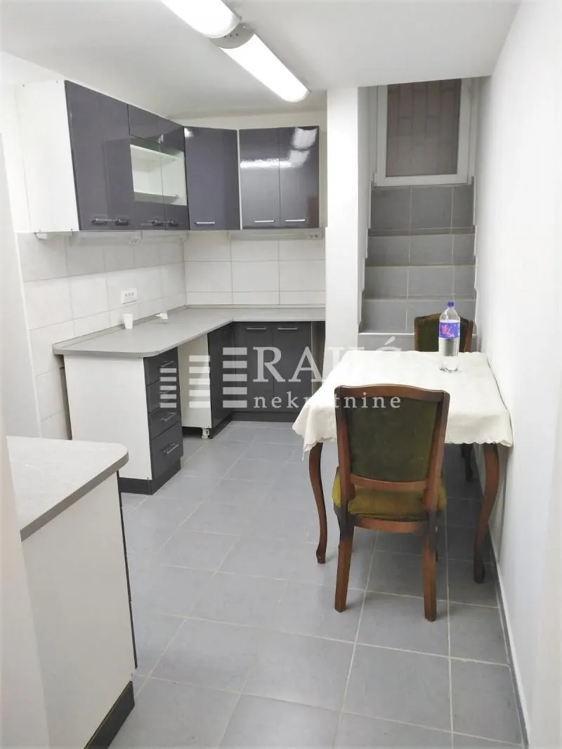 Kitchen with a dining area and stairs.