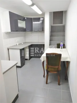 Kitchen with a dining area and stairs. - image 4