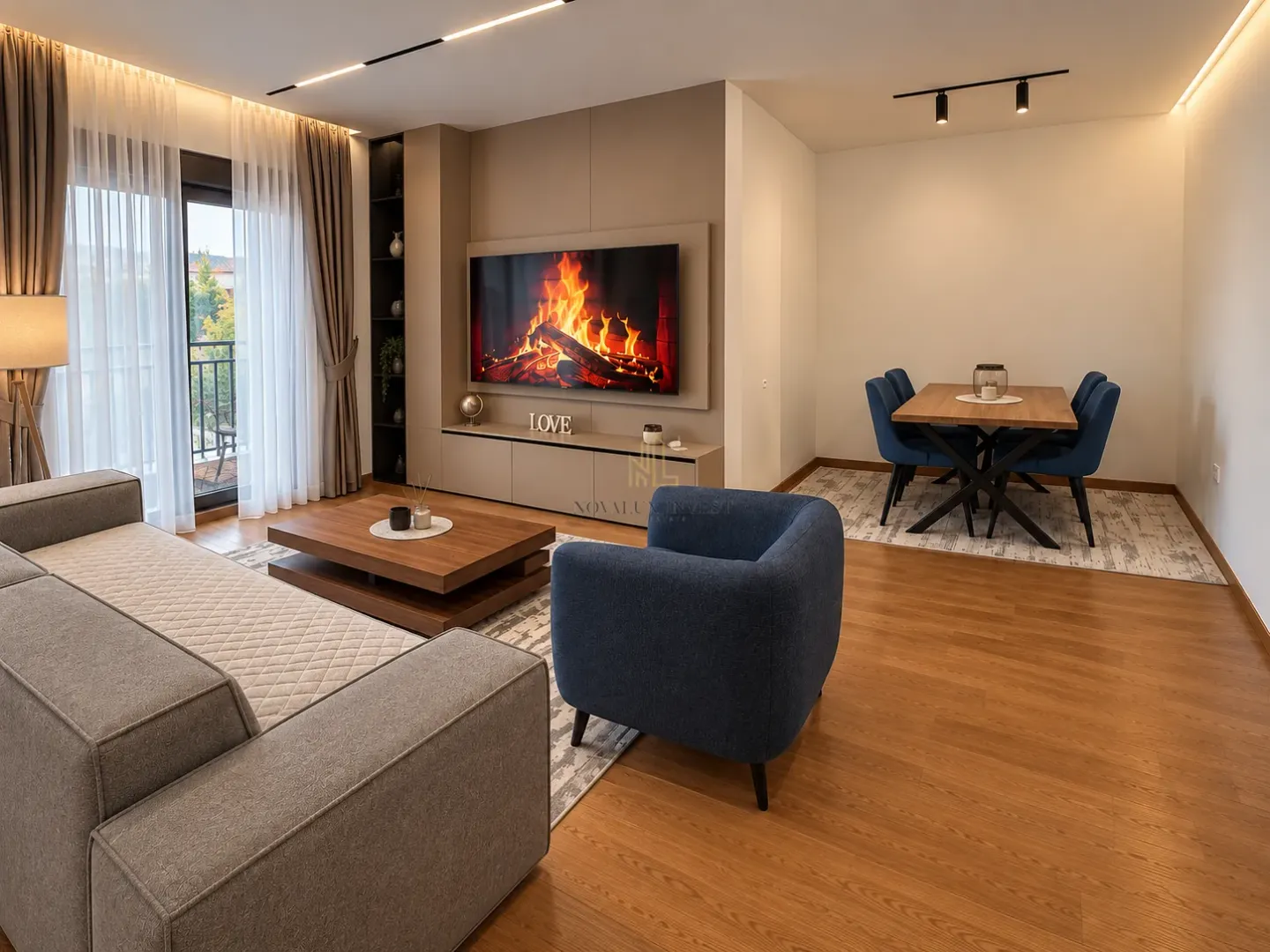Living room with sofa, TV and dining area.