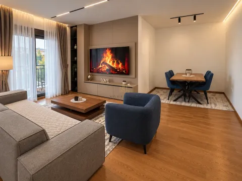 Living room with sofa, TV and dining area. - image 2