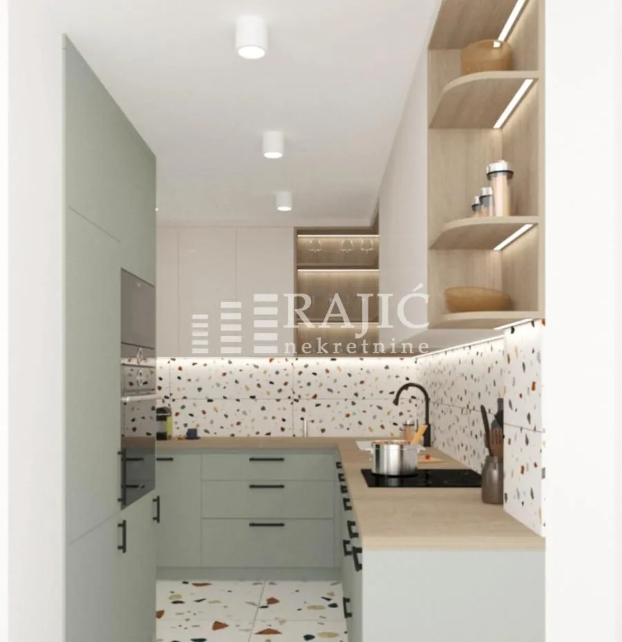 Modern kitchen with light cabinetry and built-in appliances.