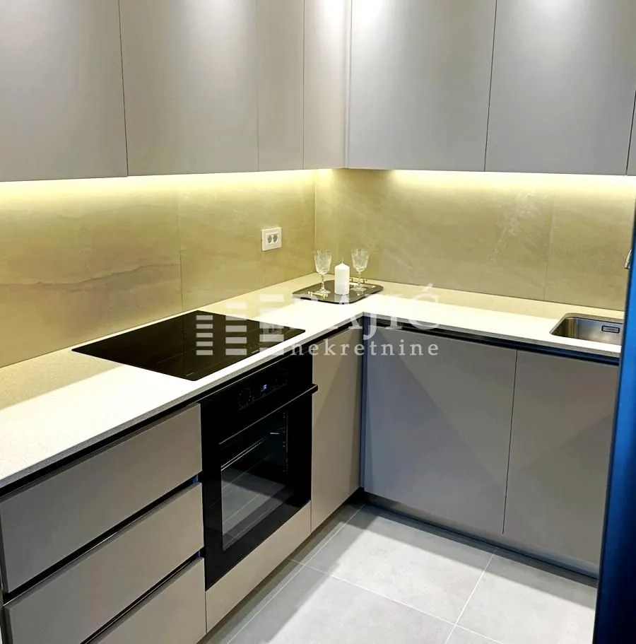 Modern and bright kitchen with built-in appliances and a countertop.