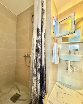 Small bathroom with a shower cabin, washbasin and window. - image 6